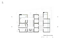 A modern architectural floor plan of a building featuring a ground-level plan with concrete flooring and multiple functional 