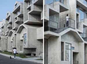 Modern residential building with concrete exterior and multiple balconies.