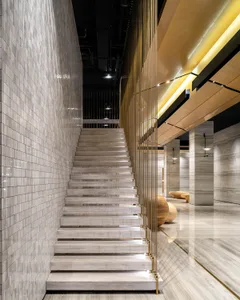 Modern minimalist staircase with concrete steps and white walls.