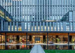A modern office building with glass and concrete materials.