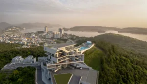 A modern residential building with concrete exterior features.