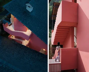 A modern residential building with a concrete exterior and spiral stairs.