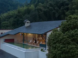 A well-designed residential lounge area with a pool and modern materials.
