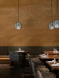 A modern restaurant interior featuring wooden walls and furnishings.