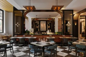 A modern restaurant interior with marble and concrete materials.