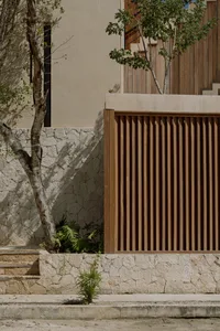 Modern urban fence with wooden slats and stone wall