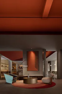 A modern lobby with metallic furniture and wooden elements.