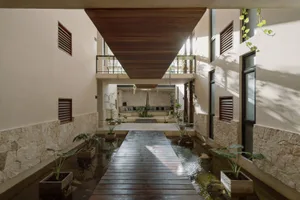 Modern residential interior design featuring wooden flooring and concrete walls.