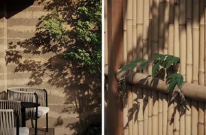 A wall adorned with bamboo poles and plants