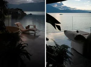 A modern design with clean lines and smooth surfaces, featuring sleek furniture overlooking calm waters with distant mountain