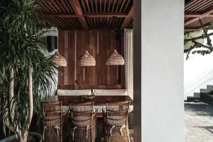 Industrial-style restaurant with wooden furniture and pendant lights.