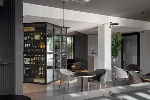 A minimalist restaurant lounge featuring glass, wood, and metal materials.