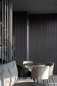 Modern cafe interior with black walls, plush velvet seating, and sleek steel accents.