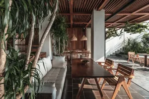 Modern coffee shop with wooden furniture and floor.