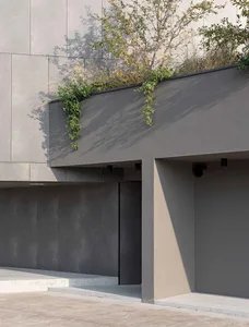 Concrete exterior facade with greenery.