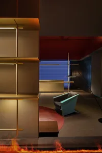 A modern hotel reception with metallic shelving and a sleek, minimalist design.