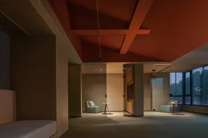 Modern hotel suite with glass walls and wooden furniture