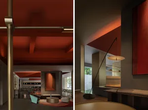 A modern interior design featuring metal, concrete, and red colors in a lounge or lobby setting.