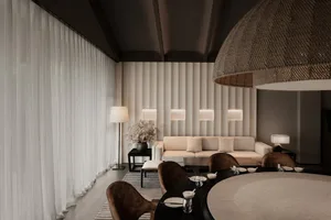 A modern living-dining room featuring textured cotton-blend curtains, textured concrete paneling, leather upholstered furnitu