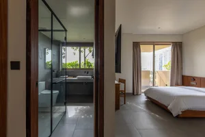 Modern minimalist bedroom featuring concrete and glass materials