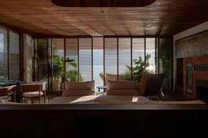 A modern residential interior featuring wooden blinds and natural light.