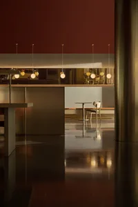 Modern interior design featuring metallic furniture in a restaurant setting.
