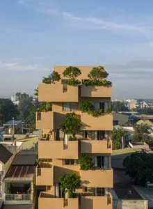 A modern building with green roofs and cladding, showcasing sustainable urban design.