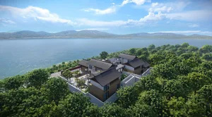 A vacation home with brick and glass walls overlooking a serene lake.