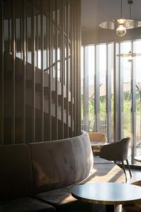 A cozy cafe bar with velvet seating and glass windows