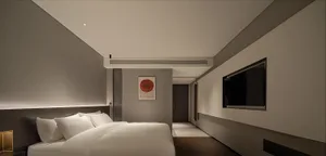 一間現代簡約臥室，配有布藝床、極簡裝飾與俐落設計。