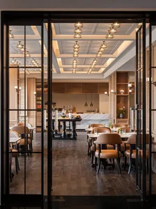 Industrial-style restaurant interior with marble countertops and wooden tables and chairs