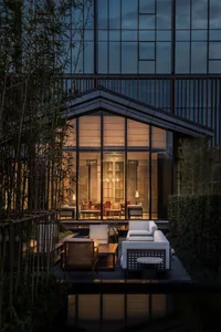 Modern minimalist terrace garden featuring wood, glass, and bamboo elements
