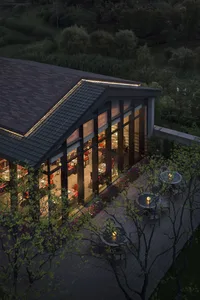 Modern residential house exterior with vibrant green landscaping and night-time ambiance