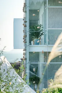 Modern interior space featuring glass balconies overlooking the ocean.