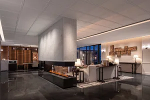 A luxurious lobby features a modern marble and concrete design.