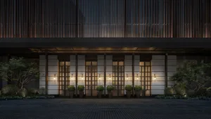 A modern office entrance featuring glass and concrete materials, with a welcoming atmosphere.