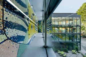 Modern office space featuring glass exterior and interior with contemporary design elements.