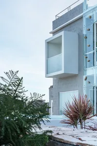 A modern residential building with glass and brick exterior.