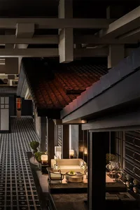 A modern industrial-style lobby with concrete flooring and minimalist decor.