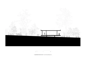 A modern building with a metal roof and sleek lines, surrounded by greenery.