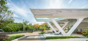 A modern building with a white marble exterior and a large sculptural entrance.