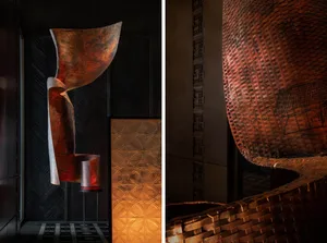 A modern interior design featuring metallic textile artwork