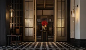 A minimalist modern lobby with glass, metal, and stone materials.