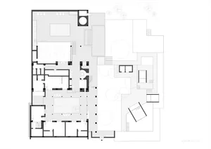Floor plan of a modern office space depicted in white lines and shapes.