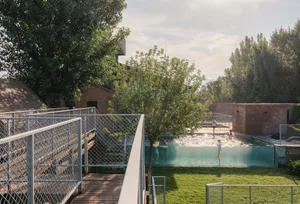 Poolside area with concrete, brick, and metal structures