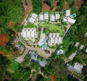 A modern residential community depicted in a rendered view showcasing contemporary architecture and greenery.