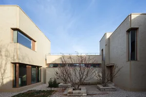 Modern residential architecture with concrete exterior and large windows.
