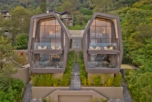 Modern residential house with concrete facade and large glass windows
