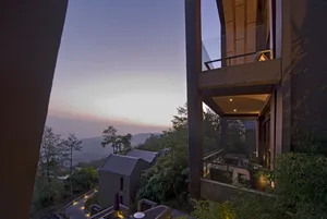 Modern residential veranda featuring wood, glass, and metal elements.