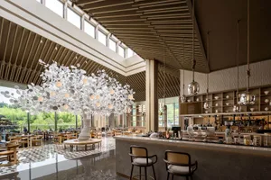 An industrial-style restaurant bar with metal and glass materials.